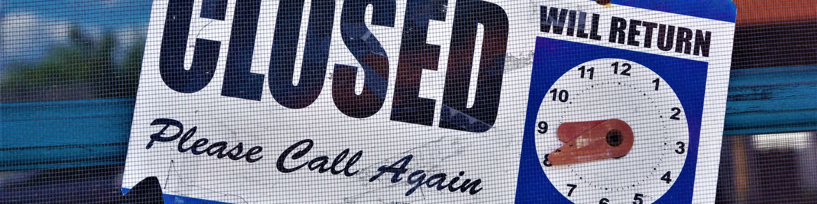 A closed sign hanging on a door